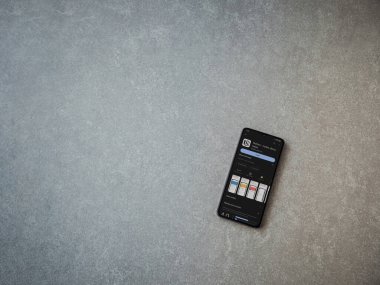 Lod, Israel - July 16,2023: Notion app play store page on smartphone on ceramic stone background. Top view flat lay with copy space.