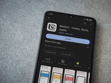 Lod, Israel - July 16,2023: Notion app play store page on smartphone on ceramic stone background. Top view flat lay with copy space.