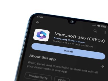 Lod, Israel - July 16,2023: Microsoft 360 app play store page on smartphone on white background. Top view flat lay with copy space.