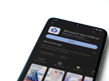 Lod, Israel - July 16,2023: Microsoft 360 app play store page on smartphone on white background. Top view flat lay with copy space.