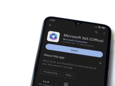 Lod, Israel - July 16,2023: Microsoft 360 app play store page on smartphone on white background. Top view flat lay with copy space.