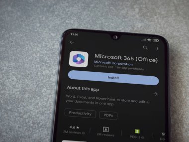 Lod, Israel - July 16,2023: Microsoft 360 app play store page on smartphone on ceramic stone background. Top view flat lay with copy space.