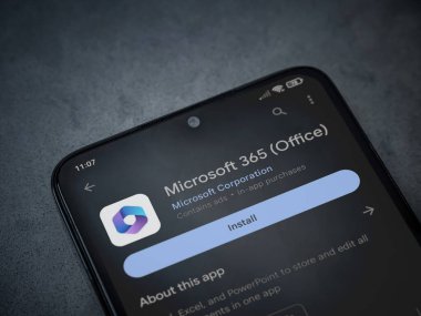 Lod, Israel - July 16,2023: Microsoft 360 app play store page on smartphone on a dark marble stone background. Top view flat lay with copy space.