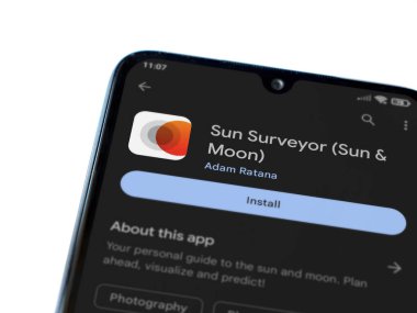 Lod, Israel - July 16,2023: Sun Surveyor app play store page on smartphone on white background. Top view flat lay with copy space.