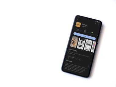 Lod, Israel - July 16,2023: Sonos app play store page on smartphone on white background. Top view flat lay with copy space.