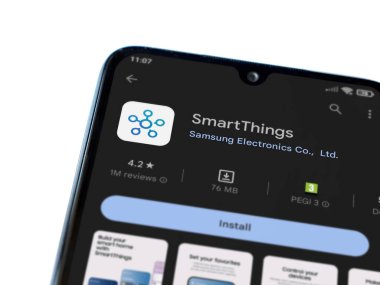 Lod, Israel - July 16,2023: Smartthings app play store page on smartphone on white background. Top view flat lay with copy space.