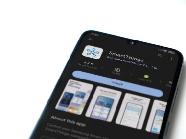 Lod, Israel - July 16,2023: Smartthings app play store page on smartphone on white background. Top view flat lay with copy space.