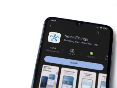 Lod, Israel - July 16,2023: Smartthings app play store page on smartphone on white background. Top view flat lay with copy space.