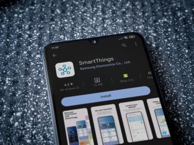 Lod, Israel - July 16,2023: Smartthings app play store page on smartphone on a metallic background. Close up top view flat lay.