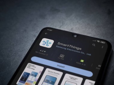 Lod, Israel - July 16,2023: Smartthings app play store page on smartphone on a dark marble stone background. Top view flat lay with copy space.