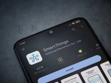 Lod, Israel - July 16,2023: Smartthings app play store page on smartphone on a dark marble stone background. Top view flat lay with copy space.
