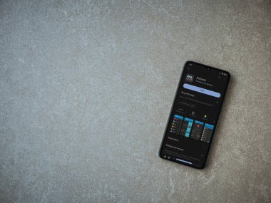 Lod, Israel - July 16,2023: PalGate app play store page on smartphone on ceramic stone background. Top view flat lay with copy space.