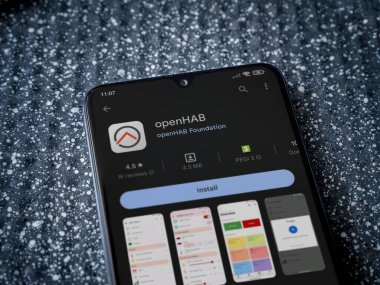 Lod, Israel - July 16,2023: openHAB app play store page on smartphone on a metallic background. Close up top view flat lay.
