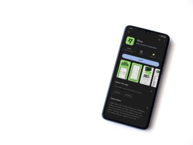 Lod, Israel - July 16,2023: Wise app play store page on smartphone on white background. Top view flat lay with copy space.