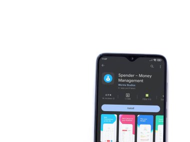 Lod, Israel - July 16,2023: Spender app play store page on smartphone on white background. Top view flat lay with copy space.