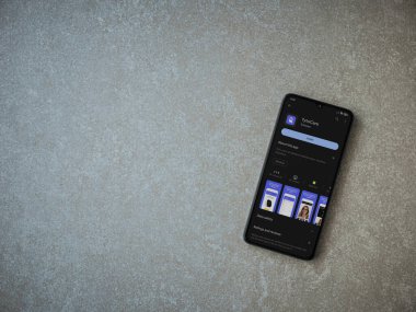 Lod, Israel - July 16,2023: TytoCare app play store page on smartphone on ceramic stone background. Top view flat lay with copy space.
