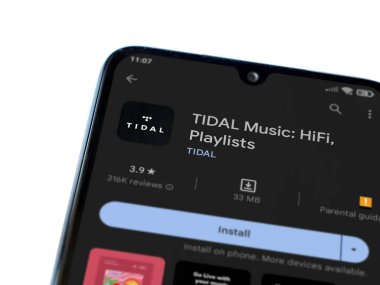 Lod, Israel - July 16,2023: TIDAL Music app play store page on smartphone on white background. Top view flat lay with copy space.