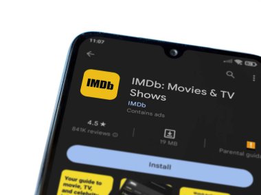 Lod, Israel - July 16,2023: IDMb app play store page on smartphone on white background. Top view flat lay with copy space.