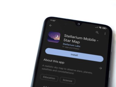 Lod, Israel - July 16,2023: Stellarium - Star Map app play store page on smartphone on white background. Top view flat lay with copy space.