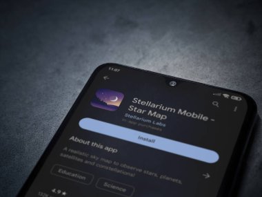 Lod, Israel - July 16,2023: Stellarium - Star Map app play store page on smartphone on a dark marble stone background. Top view flat lay with copy space.