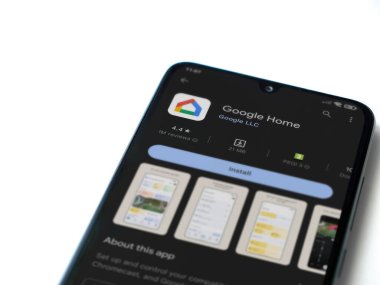 Lod, Israel - July 16,2023: Google Home app play store page on smartphone on white background. Top view flat lay with copy space.