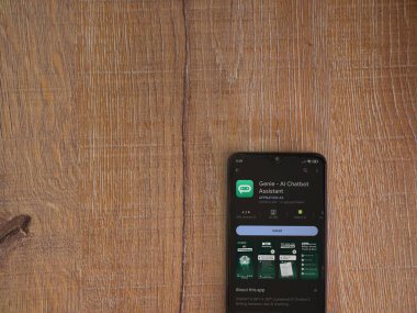 Lod, Israel - July 16,2023: Genie app play store page on smartphone on wooden background. Top view flat lay with copy space.
