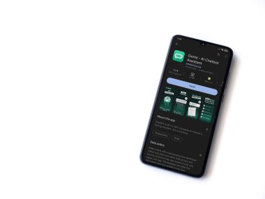 Lod, Israel - July 16,2023: Genie app play store page on smartphone on white background. Top view flat lay with copy space.
