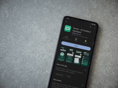 Lod, Israel - July 16,2023: Genie app play store page on smartphone on ceramic stone background. Top view flat lay with copy space.