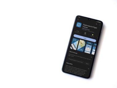 Lod, Israel - July 16,2023: Flightradar24 Flight Tracker app play store page on smartphone on white background. Top view flat lay with copy space.