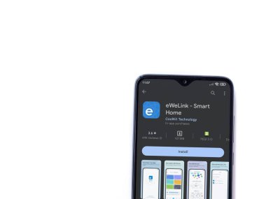 Lod, Israel - July 16,2023: eWeLink app play store page on smartphone on white background. Top view flat lay with copy space.