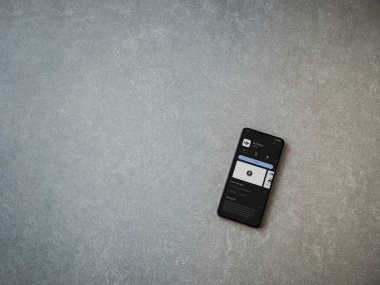 Lod, Israel - July 16,2023: DJI Store app play store page on smartphone on ceramic stone background. Top view flat lay with copy space.