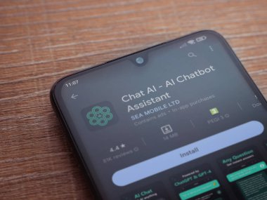 Lod, Israel - July 16,2023: Chat AI app play store page on smartphone on wooden background. Top view flat lay with copy space.