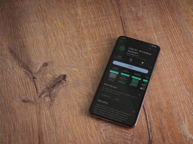 Lod, Israel - July 16,2023: Chat AI app play store page on smartphone on wooden background. Top view flat lay with copy space.