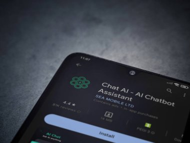 Lod, Israel - July 16,2023: Chat AI app play store page on smartphone on a dark marble stone background. Top view flat lay with copy space.