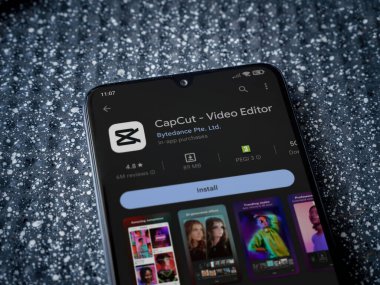 Lod, Israel - July 16,2023: CapCut app play store page on smartphone on a metallic background. Close up top view flat lay.