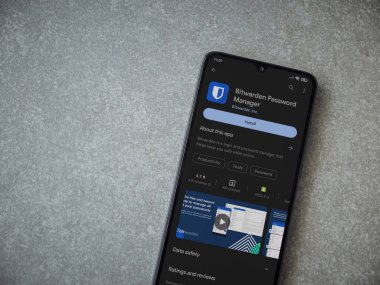 Lod, Israel - July 16,2023: Bitwarden Password Manager app play store page on smartphone on ceramic stone background. Top view flat lay with copy space.