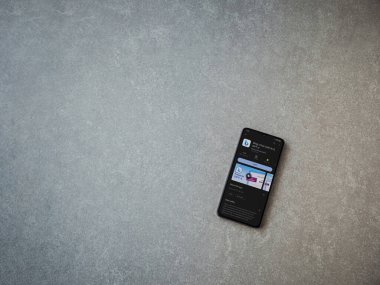 Lod, Israel - July 16,2023: Bing Browser app play store page on smartphone on ceramic stone background. Top view flat lay with copy space.