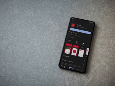 Lod, Israel - July 16,2023: Avis IL app play store page on smartphone on ceramic stone background. Top view flat lay with copy space.