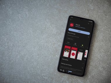 Lod, Israel - July 16,2023: Avis IL app play store page on smartphone on ceramic stone background. Top view flat lay with copy space.