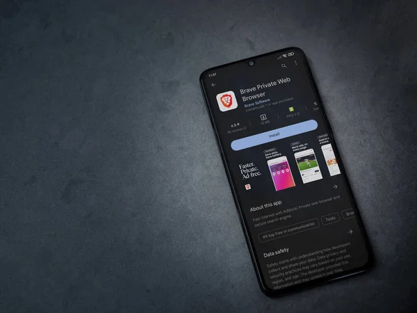 Lod, Israel - July 16,2023: Brave Private Browser app play store page on smartphone on a dark marble stone background. Top view flat lay with copy space.