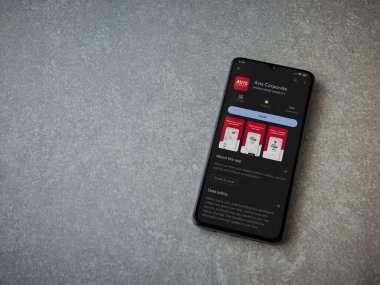 Lod, Israel - July 16,2023: Avis Corporate app play store page on smartphone on ceramic stone background. Top view flat lay with copy space.