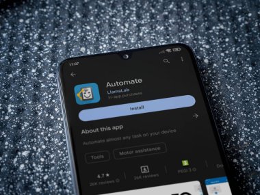 Lod, Israel - July 16,2023: Automate app play store page on smartphone on a metallic background. Close up top view flat lay.