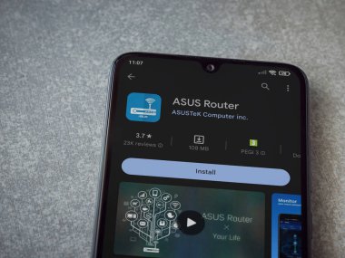 Lod, Israel - July 16,2023: ASUS Router app play store page on smartphone on ceramic stone background. Top view flat lay with copy space.