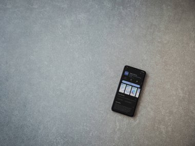 Lod, Israel - July 16,2023: Aqara Home app play store page on smartphone on ceramic stone background. Top view flat lay with copy space.