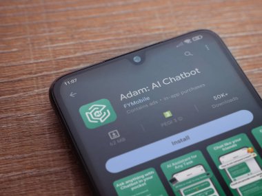 Lod, Israel - July 16,2023: Adam Ai app play store page on smartphone on wooden background. Top view flat lay with copy space.