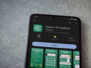Lod, Israel - July 16,2023: Adam Ai app play store page on smartphone on ceramic stone background. Top view flat lay with copy space.