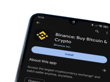 Lod, Israel - 16 Temmuz 2023: Binance uygulama oyun mağazası sayfası beyaz arka planda akıllı telefon. Üst görünüm düzlüğü kopyalama alanı ile yatıyordu.