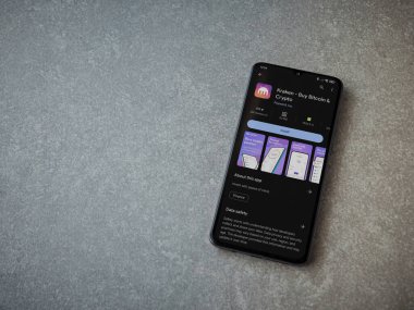 Lod, Israel - 16 Temmuz 2023: Kraken uygulama oyun mağazası sayfası seramik taş zemin üzerinde akıllı telefon. Üst görünüm düzlüğü kopyalama alanı ile yatıyordu.