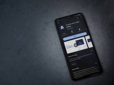 Lod, Israel - 16 Temmuz 2023: Crypto.com uygulama oyun mağazası sayfası kara mermer taşlı arka planda. Üst görünüm düzlüğü kopyalama alanı ile yatıyordu.
