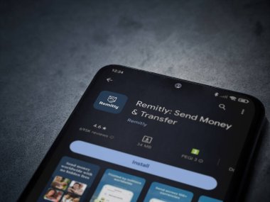 Lod, Israel - 16 Temmuz 2023: Koyu mermer taşlı arka planda akıllı telefondan uygulamalı oyun mağazası sayfası. Üst görünüm düzlüğü kopyalama alanı ile yatıyordu.